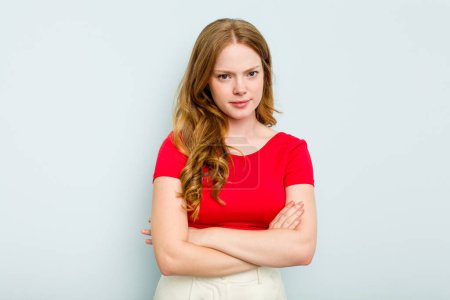 Photo for Young caucasian woman isolated on blue background suspicious, uncertain, examining you. - Royalty Free Image