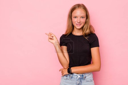 Photo for Caucasian teen girl isolated on pink background smiling cheerfully pointing with forefinger away. - Royalty Free Image