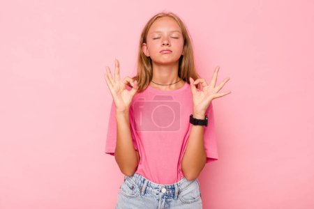Photo for Caucasian teen girl isolated on pink background relaxes after hard working day, she is performing yoga. - Royalty Free Image