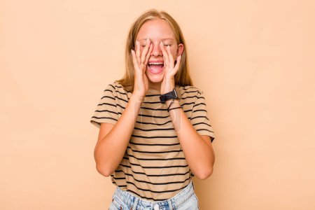 Photo for Caucasian teen girl isolated on beige background shouting excited to front. - Royalty Free Image