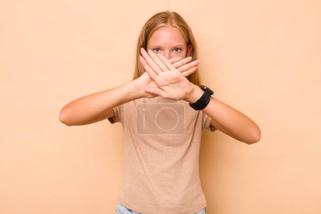 Photo for Caucasian teen girl isolated on beige background doing a denial gesture - Royalty Free Image