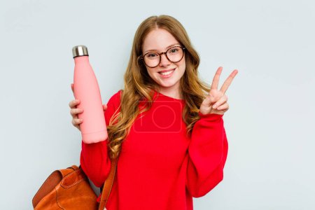 Photo for Young student woman holding a canteen isolated on blue background showing number two with fingers. - Royalty Free Image