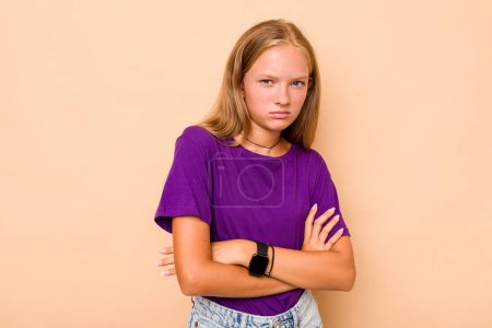Photo for Caucasian teen girl isolated on beige background suspicious, uncertain, examining you. - Royalty Free Image
