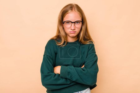 Photo for Caucasian teen girl isolated on beige background shrugs shoulders and open eyes confused. - Royalty Free Image