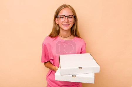 Téléchargez les photos : Petite fille caucasienne tenant la pizza isolée sur fond beige riant et s'amusant. - en image libre de droit