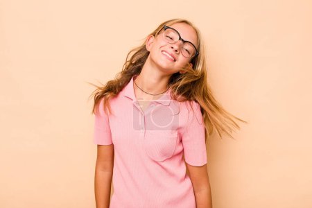Photo for Caucasian teen girl isolated on beige background dancing and having fun. - Royalty Free Image