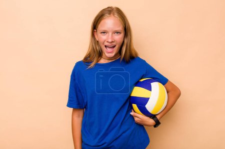 Photo for Little caucasian girl playing volleyball isolated on beige background screaming very angry and aggressive. - Royalty Free Image