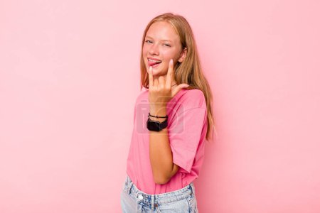 Photo for Caucasian teen girl isolated on pink background showing rock gesture with fingers - Royalty Free Image