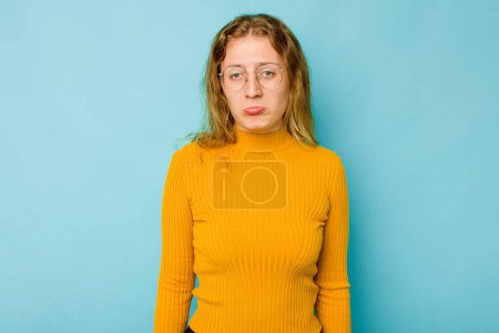 Photo for Young caucasian woman isolated on blue background sad, serious face, feeling miserable and displeased. - Royalty Free Image