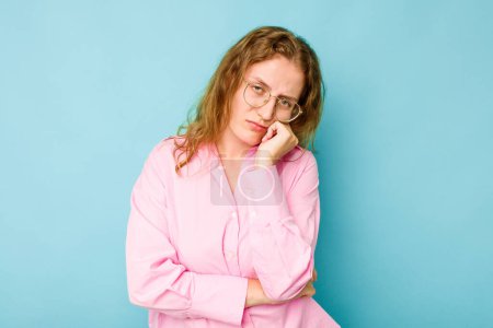 Photo for Young caucasian woman isolated on blue background tired of a repetitive task. - Royalty Free Image