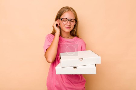 Photo for Little caucasian girl holding pizza isolated on beige background covering ears with hands. - Royalty Free Image