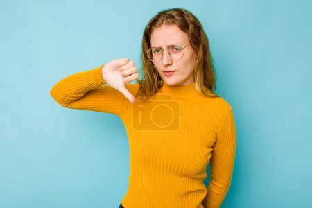 Photo for Young caucasian woman isolated on blue background showing thumb down, disappointment concept. - Royalty Free Image