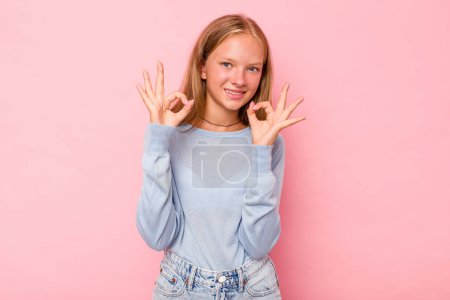 Photo for Caucasian teen girl isolated on pink background cheerful and confident showing ok gesture. - Royalty Free Image