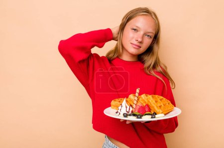 Photo for Little caucasian girl holding a waffles isolated on beige background touching back of head, thinking and making a choice. - Royalty Free Image