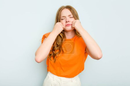 Photo for Young caucasian woman isolated on blue background whining and crying disconsolately. - Royalty Free Image
