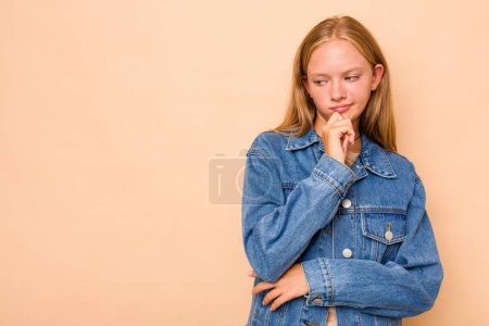 Photo for Caucasian teen girl isolated on beige background looking sideways with doubtful and skeptical expression. - Royalty Free Image