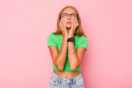 Photo for Caucasian teen girl isolated on pink background whining and crying disconsolately. - Royalty Free Image