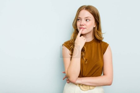 Photo for Young caucasian woman isolated on blue background looking sideways with doubtful and skeptical expression. - Royalty Free Image