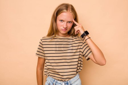 Photo for Caucasian teen girl isolated on beige background pointing temple with finger, thinking, focused on a task. - Royalty Free Image