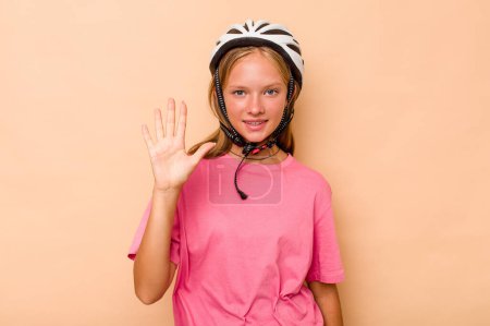 Photo for Little caucasian girl wearing a bike helmet isolated on beige background smiling cheerful showing number five with fingers. - Royalty Free Image