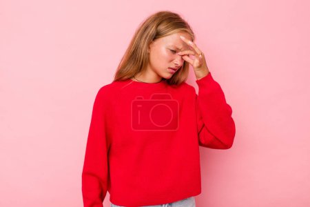 Photo for Caucasian teen girl isolated on pink background having a head ache, touching front of the face. - Royalty Free Image