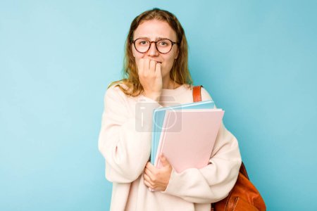Photo for Young student caucasian woman isolated on blue background biting fingernails, nervous and very anxious. - Royalty Free Image