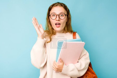 Photo for Young student caucasian woman isolated on blue background surprised and shocked. - Royalty Free Image