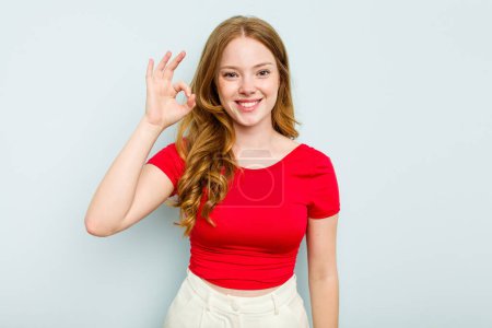 Photo for Young caucasian woman isolated on blue background cheerful and confident showing ok gesture. - Royalty Free Image