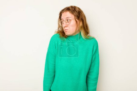 Photo for Young caucasian woman isolated on white background shrugs shoulders and open eyes confused. - Royalty Free Image