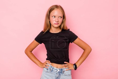 Photo for Caucasian teen girl isolated on pink background confused, feels doubtful and unsure. - Royalty Free Image