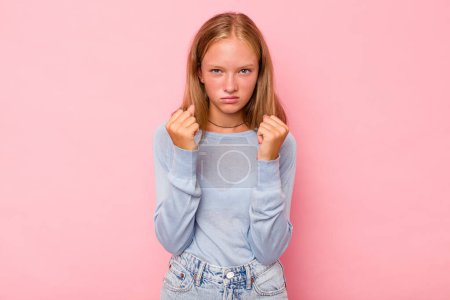 Photo for Caucasian teen girl isolated on pink background showing fist to camera, aggressive facial expression. - Royalty Free Image