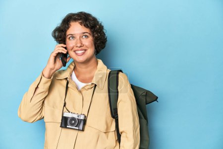 Photo for Happy young traveler woman with vintage camera, backpack, talking on phone. - Royalty Free Image