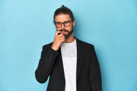 Photo for Businessman in suit with eyeglasses and beard biting fingernails, nervous and very anxious. - Royalty Free Image