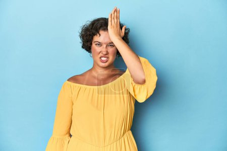 Photo for Young Caucasian woman with short hair forgetting something, slapping forehead with palm and closing eyes. - Royalty Free Image