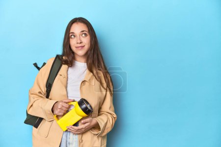 Photo for Adventurous woman with flashlight and backpack ready to explore dreaming of achieving goals and purposes - Royalty Free Image