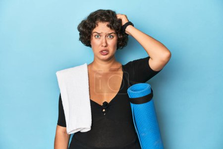 Photo for Athletic young woman with yoga mat being shocked, she has remembered important meeting. - Royalty Free Image