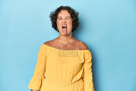 Photo for Young Caucasian woman with short hair funny and friendly sticking out tongue. - Royalty Free Image
