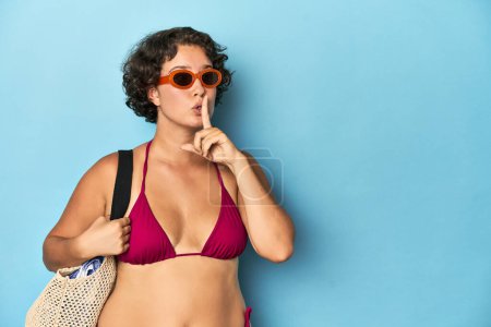 Photo for Young woman in bikini with beach bag keeping a secret or asking for silence. - Royalty Free Image