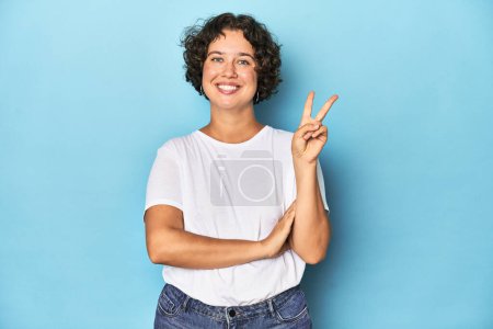 Photo for Young Caucasian woman with short hair showing number two with fingers. - Royalty Free Image