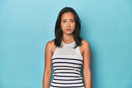 Photo for Filipina young woman on blue studio sad, serious face, feeling miserable and displeased. - Royalty Free Image