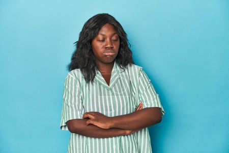 Photo for Young african american curvy woman tired of a repetitive task. - Royalty Free Image
