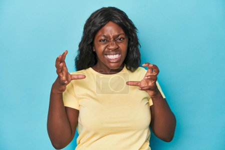 Foto de Joven africano americano curvas mujer molesto gritando con las manos tensas. - Imagen libre de derechos