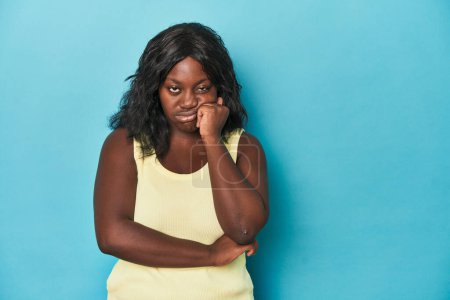Photo for Young african american curvy woman who feels sad and pensive, looking at copy space. - Royalty Free Image