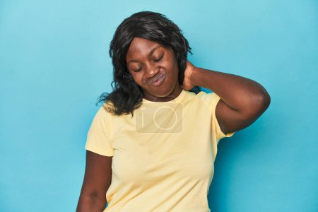 Téléchargez les photos : Jeune femme afro-américaine courbée souffrant de douleurs au cou dues à un mode de vie sédentaire. - en image libre de droit