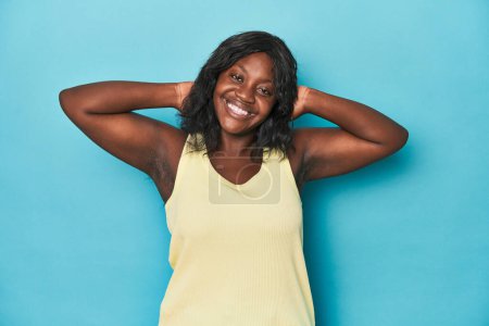 Photo for Young african american curvy woman stretching arms, relaxed position. - Royalty Free Image