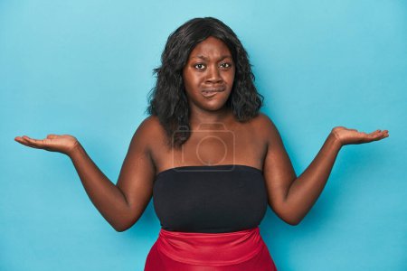 Photo for Young african american curvy woman confused and doubtful shrugging shoulders to hold a copy space. - Royalty Free Image