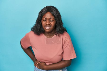Photo for Young african american curvy woman having a liver pain, stomach ache. - Royalty Free Image