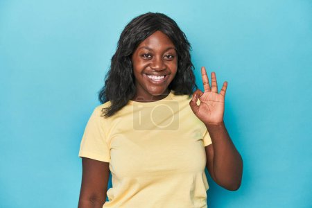 Photo for Young african american curvy woman cheerful and confident showing ok gesture. - Royalty Free Image
