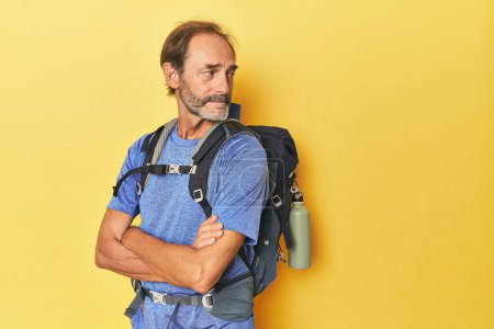 Téléchargez les photos : Homme aventureux avec sac à dos de montagne en studio - en image libre de droit