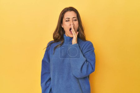 Photo for Portrait of beautiful adult woman yawning showing a tired gesture covering mouth with hand. - Royalty Free Image